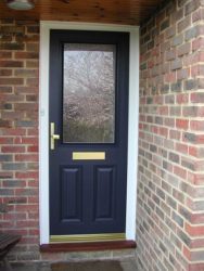 Blue composite entrance door with a white frame