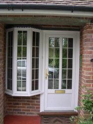 White PVC entrance door and bay window