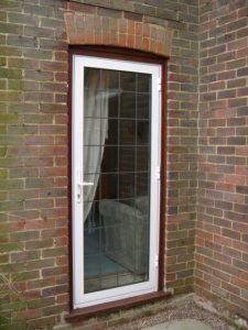 White aluminium entrance door with leaded glass
