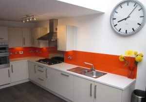 Orange kitchen glass splash back