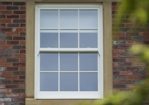 White pvc sliding sash window with a concrete frame